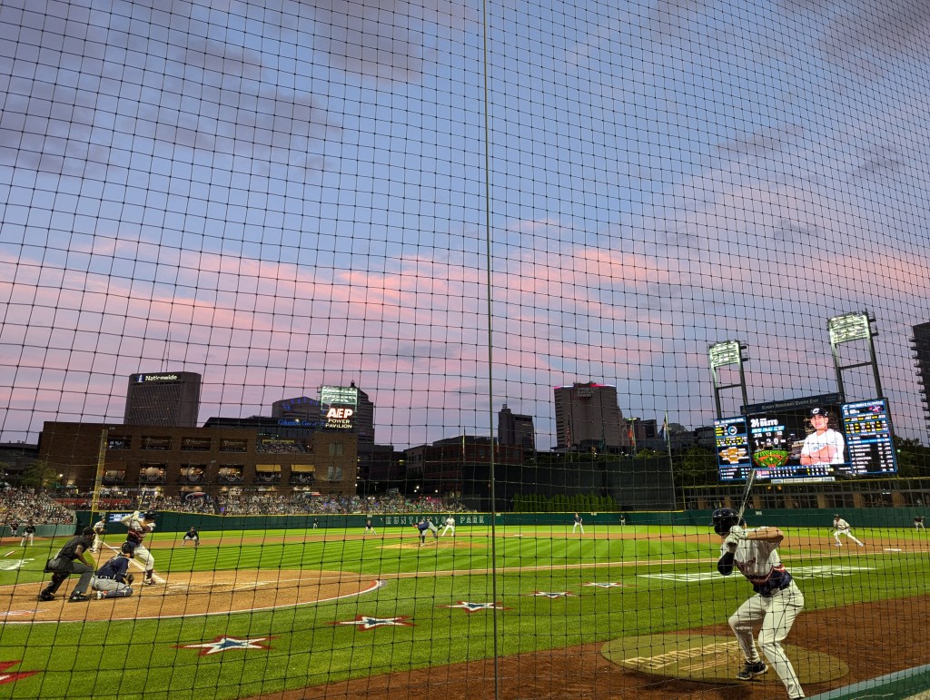 A dusk sky over downtown Columbus as seen from Huntington Park during a Columbus Clippers baseball game.