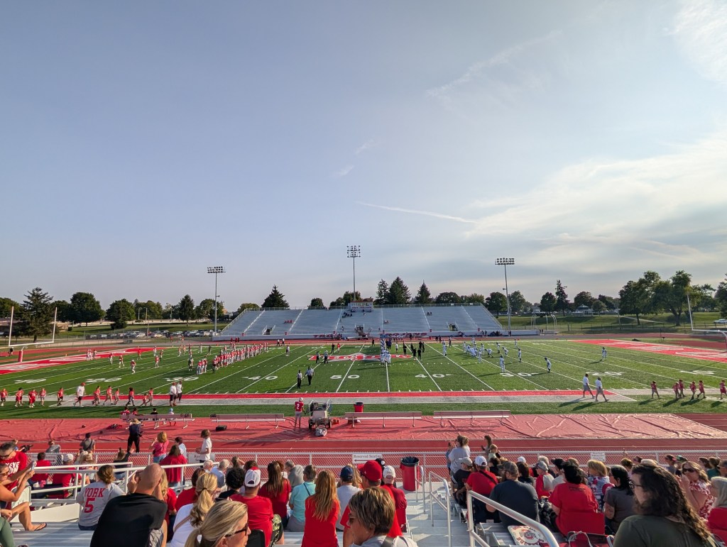 A high school football stadium during pregame warmups